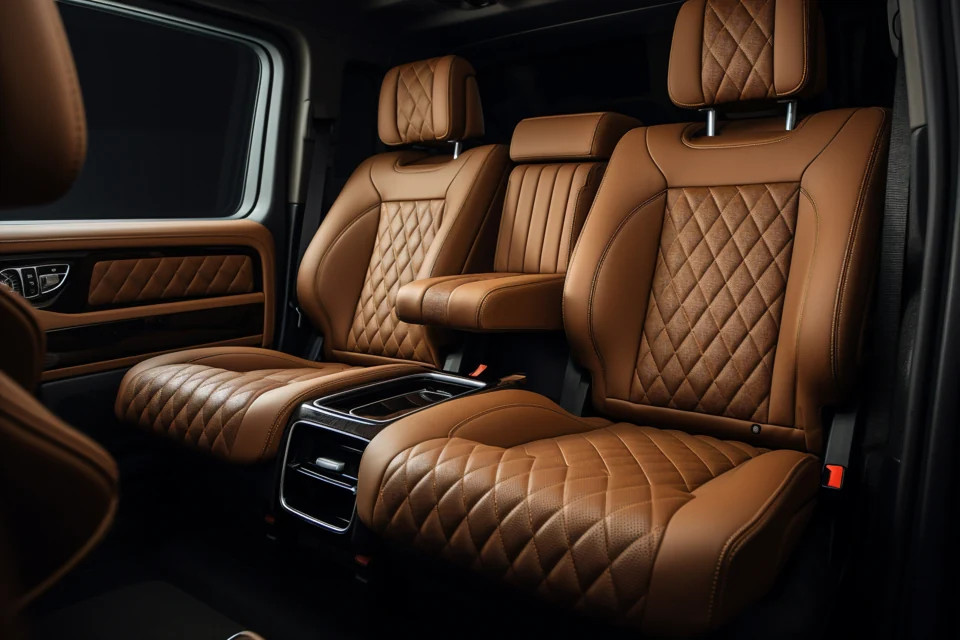 Rich cognac leather seats with diamond quilting inside an elegant vehicle.